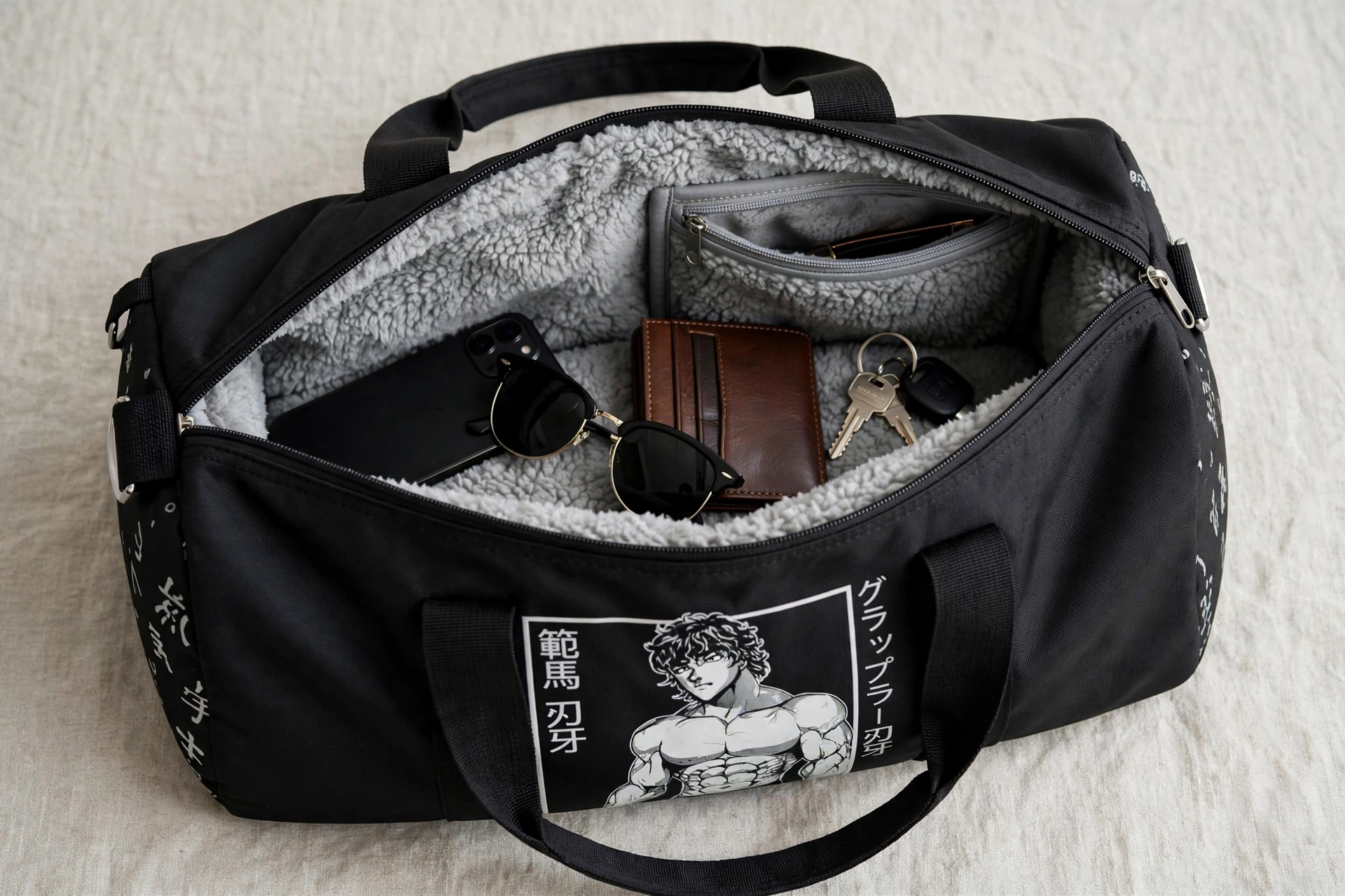 Black duffle bag with anime graphic open showing soft grey fleece lining and internal zip pockets holding smartphone sunglasses wallet and keys - scratch-resistant valuables pockets